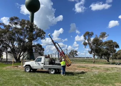 A Toyota Landcruiser with a geotechnical drill rig attached, parked at an industrial site in Melbourne, Australia. A geotechnical engineer prepares for site classification.