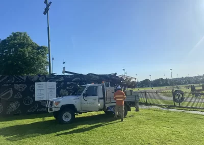 A Probe Geotech engineer surveys a bare Melbourne landscape with a solar panel already installed, ready for future renewable energy. Build your sustainable vision with confidence – rely on Probe Geotech's expert land surveying.