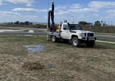 A powerful geotechnical drill rig bores into the soil at a Melbourne construction site